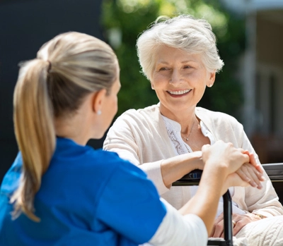 Nurse taking care of older patient.